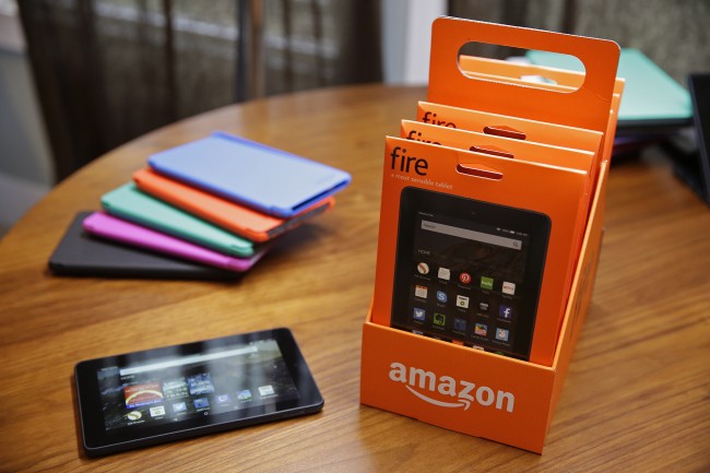 In this Wednesday, Sept. 16, 2015, photo, Amazon's new $50 Fire tablet sits on display along with assorted colored cases, background, in San Francisco. Amazon.com is introducing the $50 tablet computer in its latest attempt to boost its online store sales by luring consumers who cant afford more expensive Internet-connected devices made by Apple and other rivals. (AP Photo/Eric Risberg)